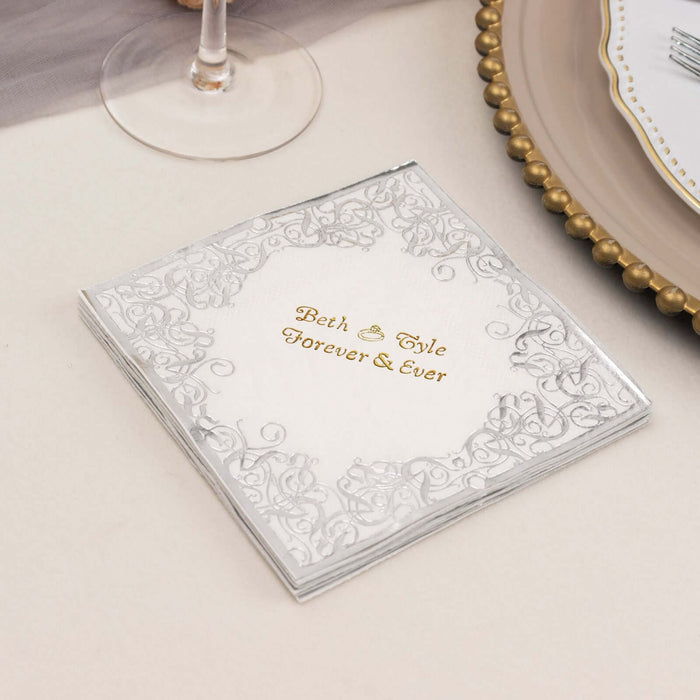 Elegant wedding napkins with silver filigree design and gold lettering.
